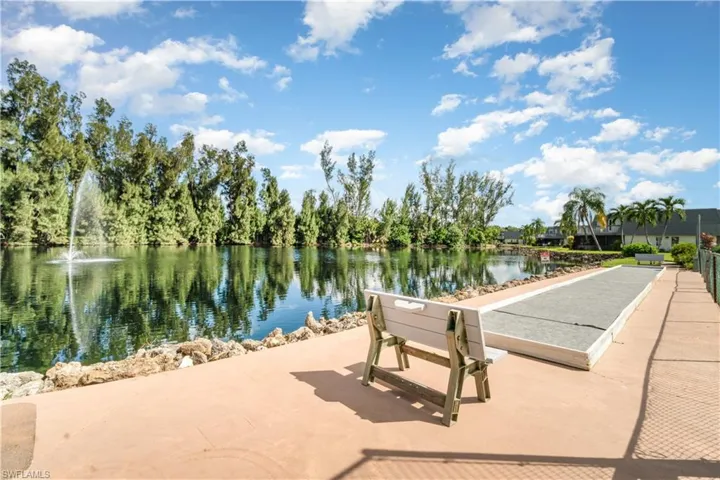 View of home's community featuring a water view and a game area