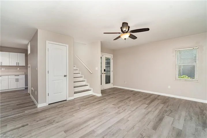 Unfurnished living room with light wood-type flooring and a ceiling fan