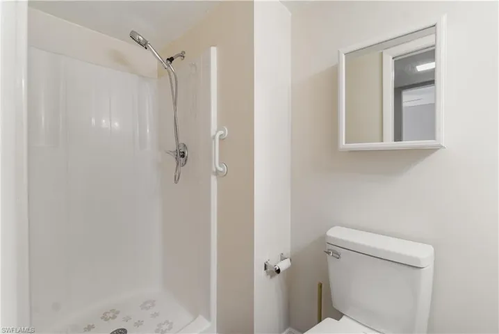 Bathroom with toilet and a stall shower