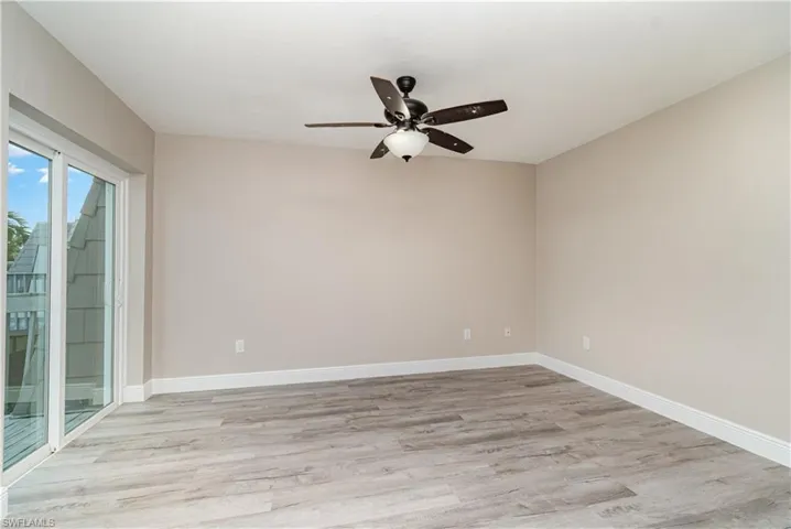 Unfurnished room featuring light wood-type flooring and ceiling fan
