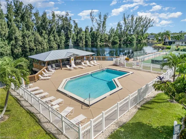 Community pool with a patio area and a water view