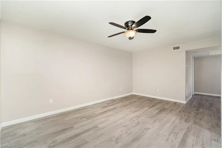 Empty room with light wood-type flooring and ceiling fan