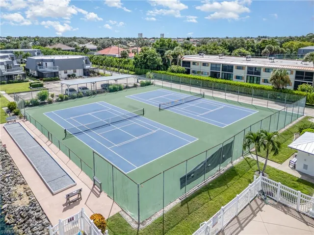 View of tennis court with community basketball court