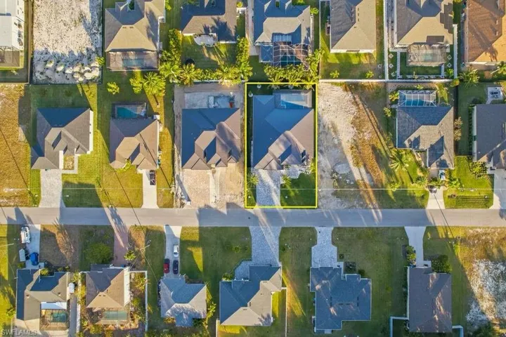 Aerial perspective of suburban area with property boundaries highlighted