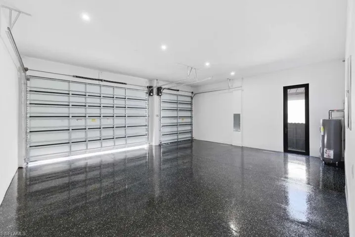 Garage with gas water heater and recessed lighting