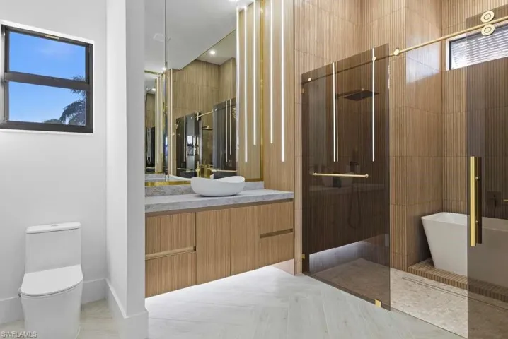 Bathroom with vanity, tiled shower, and a freestanding tub