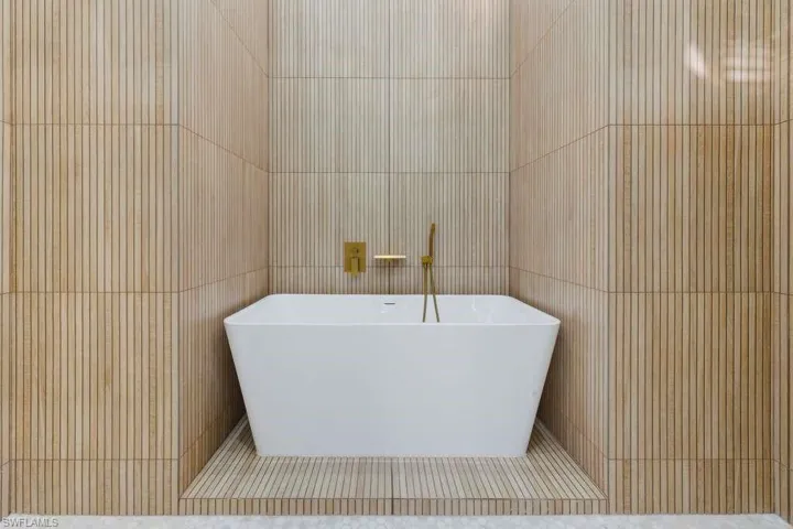 Bathroom with tile walls and a freestanding bath