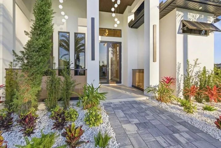 Property entrance featuring stucco siding and french doors