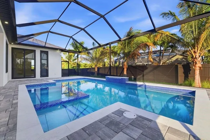 Integrated pool / spa featuring a lanai, a sunroom, a patio, and a fenced backyard