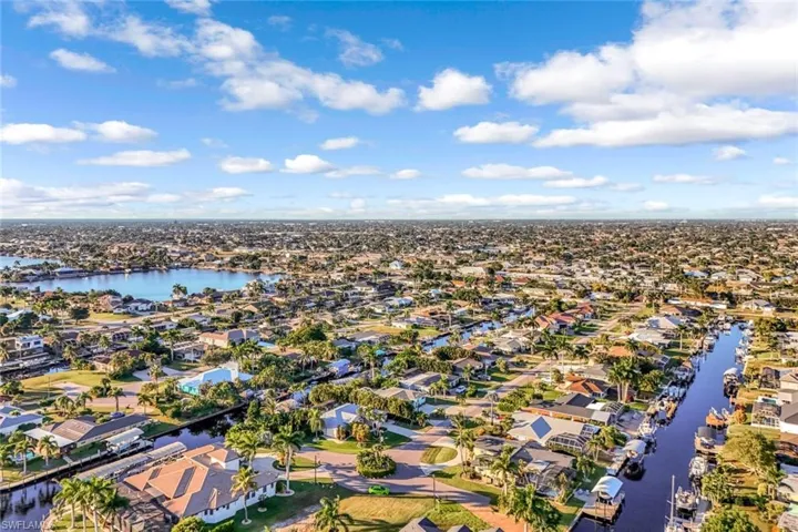 Aerial perspective of suburban area featuring a nearby body of water