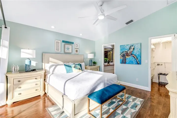 Bedroom featuring dark wood-type flooring, a walk in closet, ceiling fan, recessed lighting, and ensuite bathroom