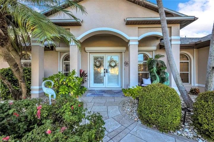 Entrance to property featuring stucco siding and french doors