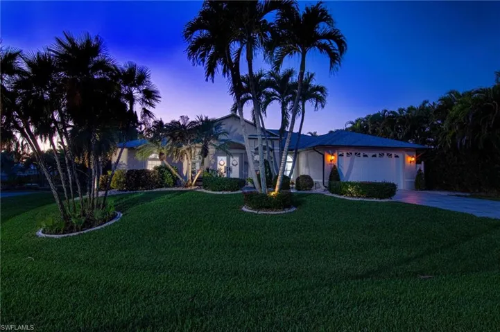Single story home featuring a yard, concrete driveway, and an attached garage