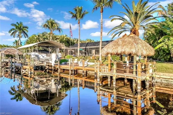 Dock area with boat lift and a water view