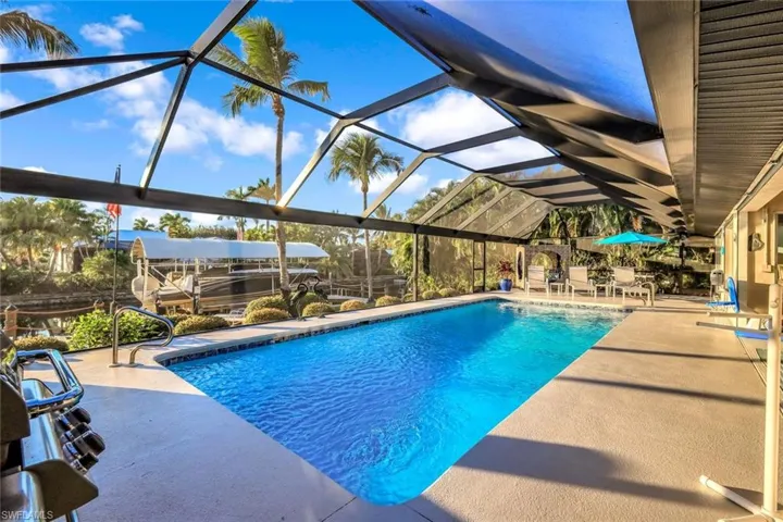 Swimming pool featuring a lanai, a patio area, and a sunroom
