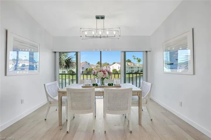 Dining room featuring light wood-type flooring and baseboards