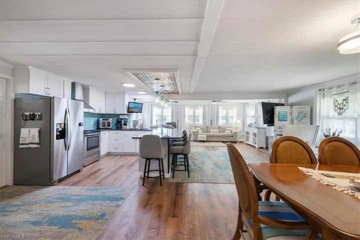 Dining area featuring beamed ceiling, wood finished floors, and a toaster