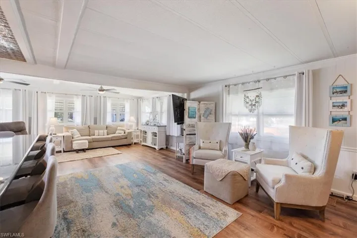 Living area featuring wood finished floors and a ceiling fan