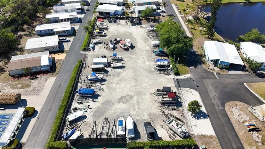 Birds eye view of property with a water view