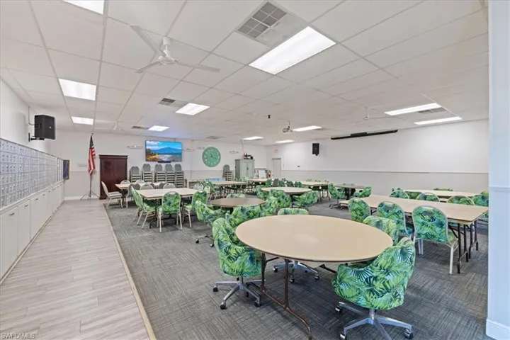 Dining area with visible vents, mail area, a paneled ceiling, and wood finished floors