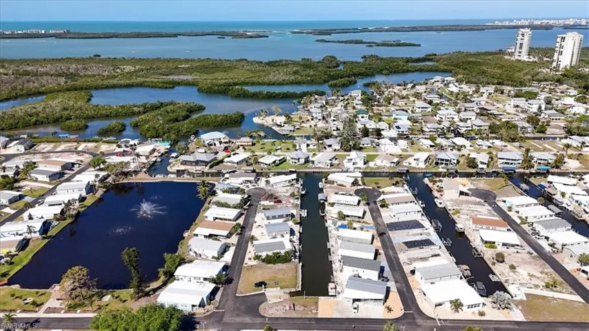 Birds eye view of property featuring a water view and a residential view