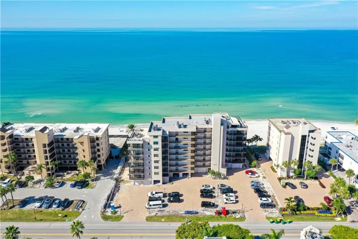 Drone / aerial view featuring a beach view and a water view