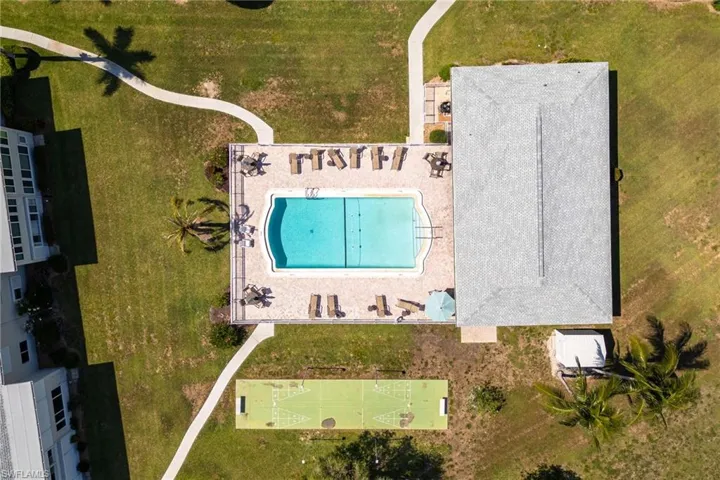 Aerial depiction of a rectangular swimming pool with integrated steps, surrounded by a paved deck