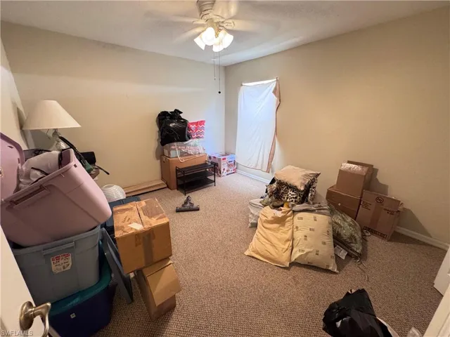 Bedroom featuring carpet, baseboards, and a ceiling fan