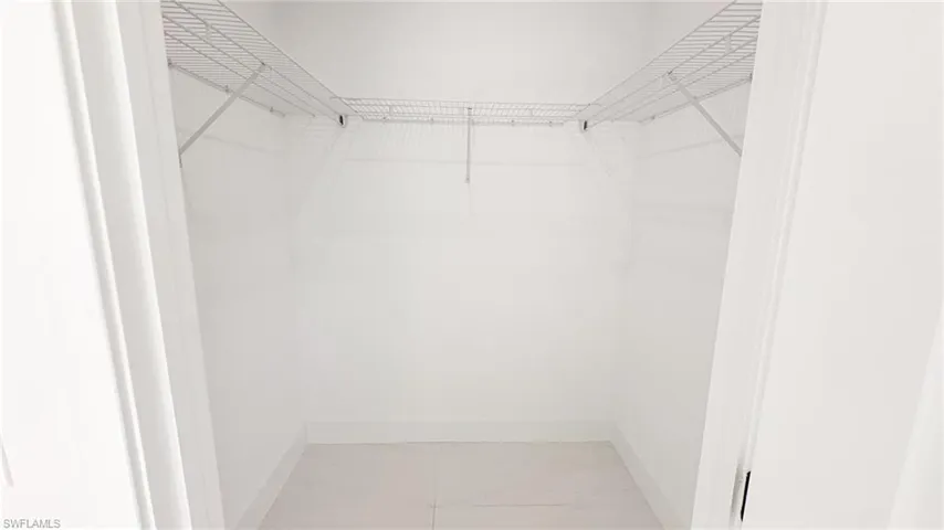 Recessed closet featuring white wire shelving, baseboard trim, and light-toned flooring