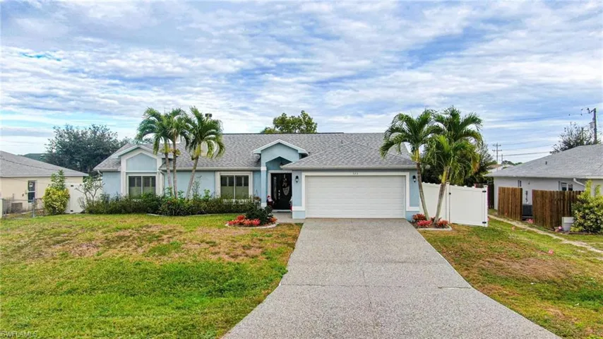Ranch-style house with stucco siding, driveway, an attached garage, and roof with shingles