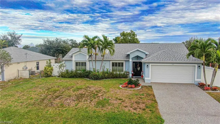 Ranch-style home featuring a shingled roof, decorative driveway, stucco siding, and a garage