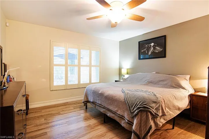Bedroom with wood-type flooring and a ceiling fan
