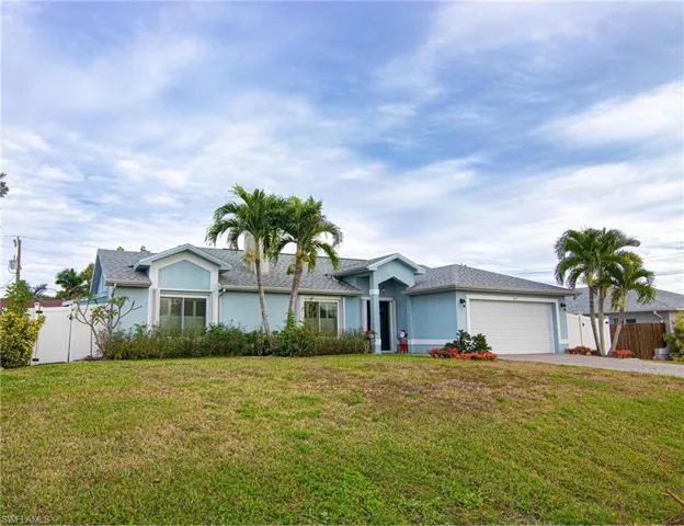Ranch-style home with stucco siding, driveway, and an attached garage