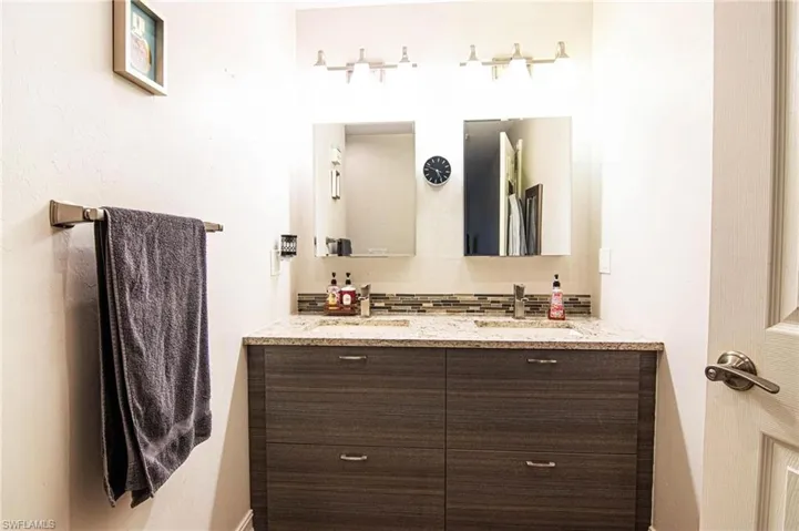 Bathroom with vanity and backsplash