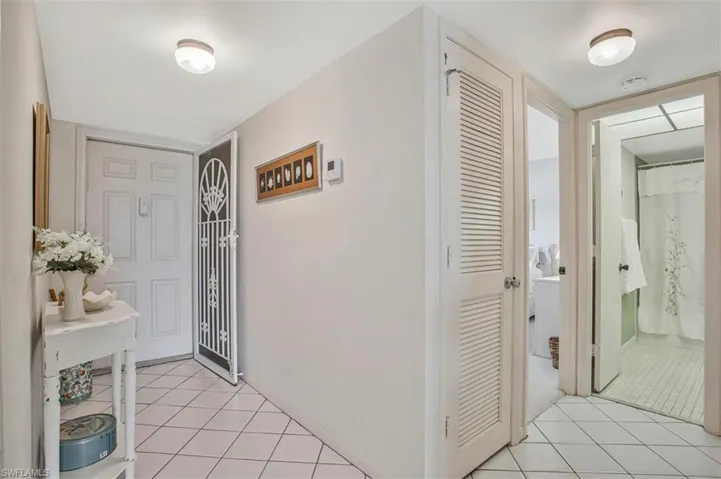 Spacious Foyer entrance featuring easy clean tile floors and a small table for keys and other things you want to keep handy.