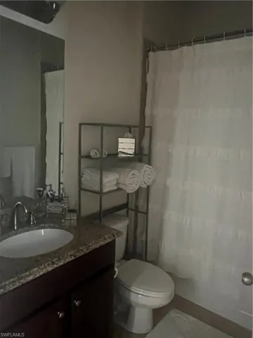 Bathroom with vanity and a shower with shower curtain