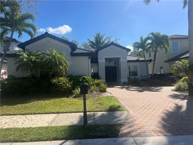Single story home featuring a front yard and stucco siding