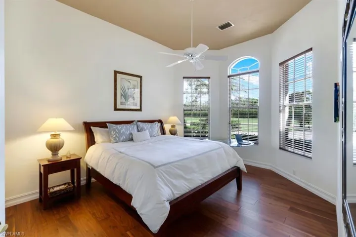 Bedroom with ceiling fan and dark hardwood / wood-style flooring
