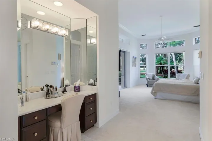 Bathroom with vanity, ceiling fan, and ornamental molding
