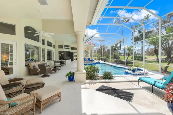 View of swimming pool with a patio area, an outdoor living space, glass enclosure, and ceiling fan