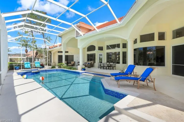 View of pool with a patio area and a lanai