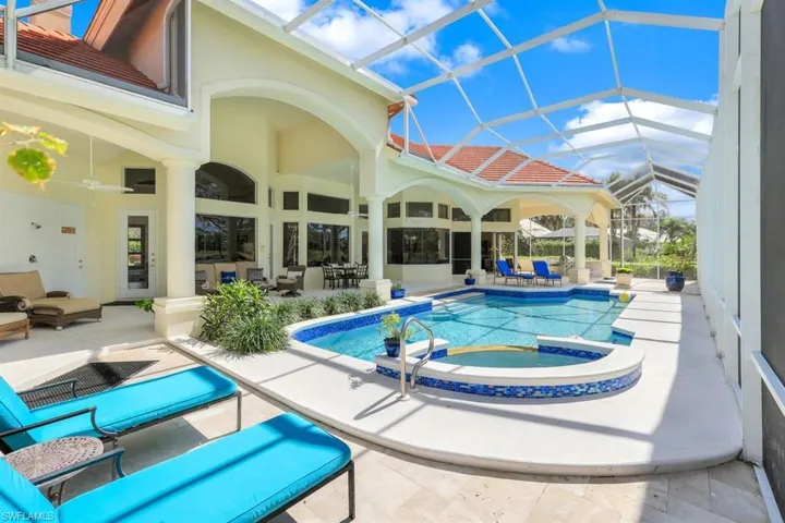 View of pool with ceiling fan, an outdoor hangout area, glass enclosure, a patio area, and an in ground hot tub