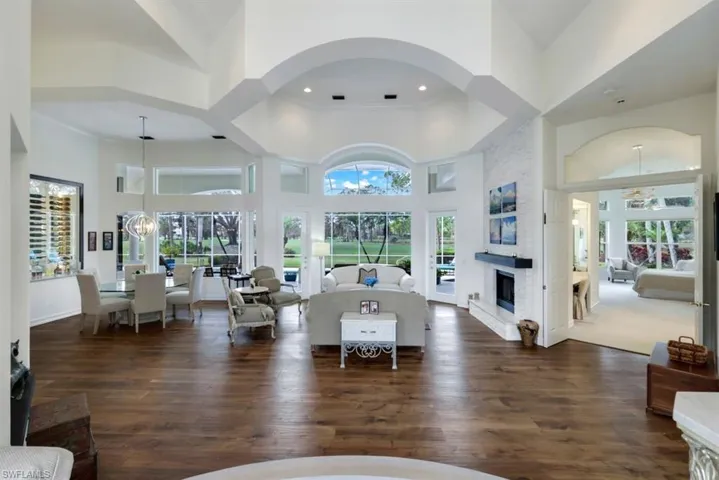 Living room featuring a towering ceiling and an inviting chandelier
