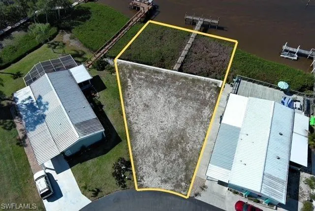 Aerial view of property and surrounding area featuring property parcel outlined