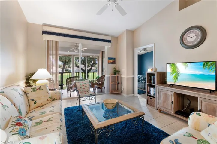 Living room featuring ceiling fan and light tile patterned flooring