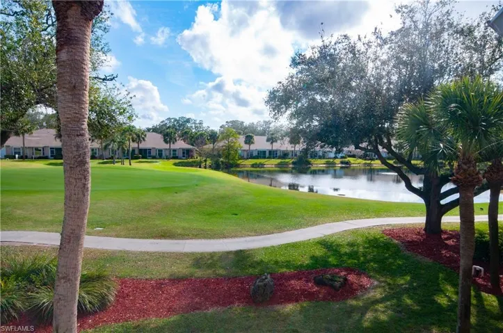 View of property's community featuring a water view and a yard
