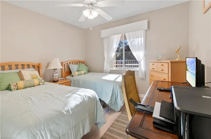 Bedroom featuring ceiling fan and light wood-style floors exclude desk & chair