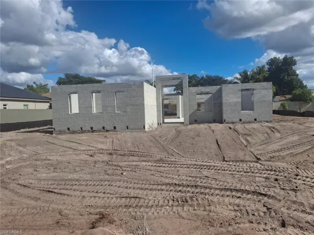 View of front facade with concrete block siding