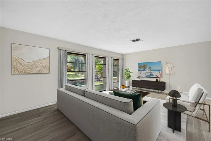 Virtually StagedLiving area with wood finished floors and a textured ceiling