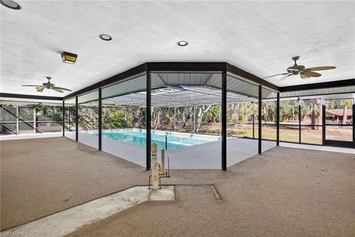 Outdoor pool with a lanai, a sunroom, and a patio